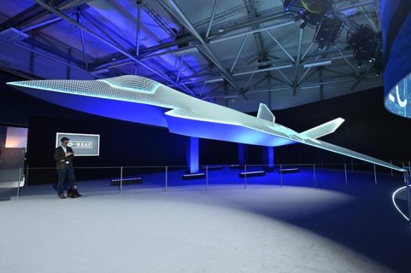 A person stands beside the Global Combat Air Programme (GCAP) 6th generation fighter jet co<em></em>ncept design on the opening day of the Farnborough Internatio<em></em>nal Airshow 2024 on July 22, 2024. (AFP)