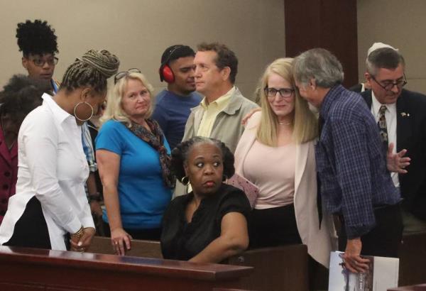 Leanna Depa (second from right) attends her adoptive son's sentencing hearing on Aug. 6, 2024.