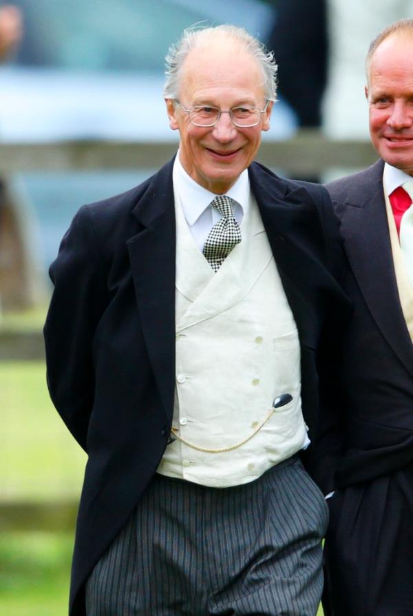 Baron Robert Fellowes attending the wedding of James Meade and Lady Laura Marsham at the Parish Church of St. Nicholas in Gayton, England.