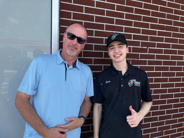 A man and boy standing next to each other, discussing weed sales politics in Ohio