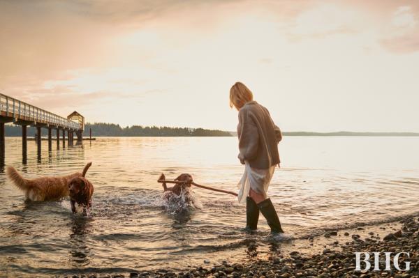 Pamela Anderson in water playing with dogs. 