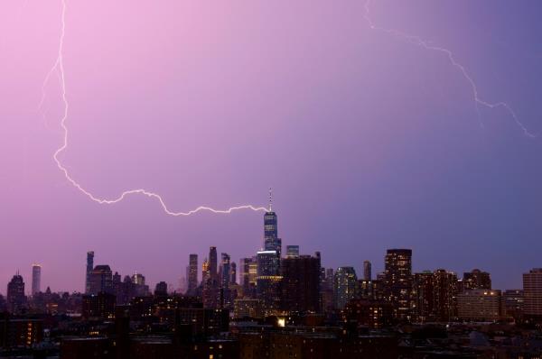 A lightning bolt strikes One World Trade Center in lower Manhattan during a thunderstorm in New York City on August 3, 2024.