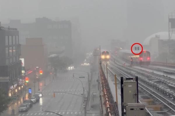 Subway surfing knuckleheads ride atop Queens train in downpour.