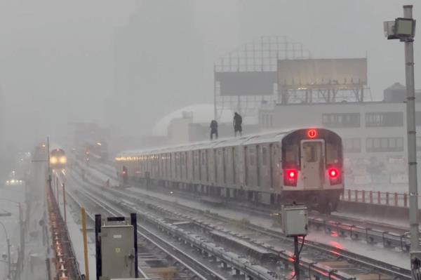 Subway surfing knuckleheads ride atop Queens train in downpour.