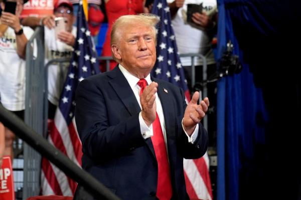 Republican presidential candidate former President Do<em></em>nald Trump claps at a campaign rally at Georgia State University in Atlanta, Saturday, Aug. 3, 2024.