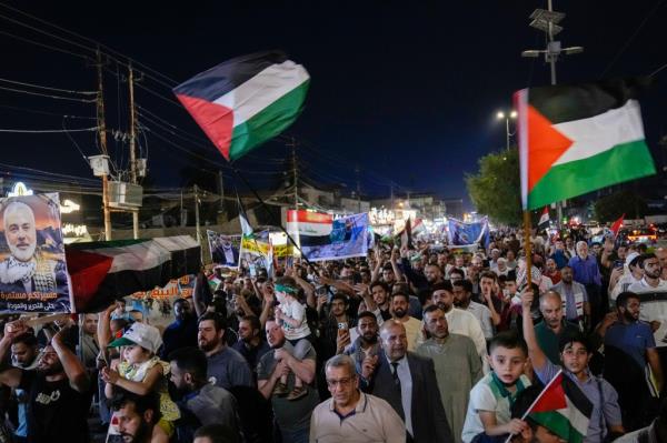 People waving Palestinian flags during a rally in Baghdad, Iraq on Aug. 3, 2024.