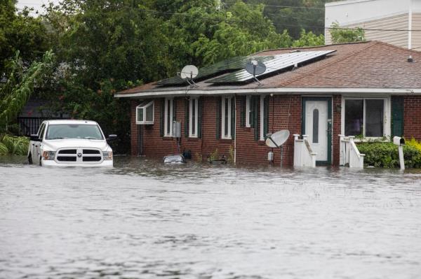 Flood waters approach a home along Spruill Ave in North Charleston, S.C., as Tropical Storm Debby approaches, Tuesday, Aug. 6, 2024.