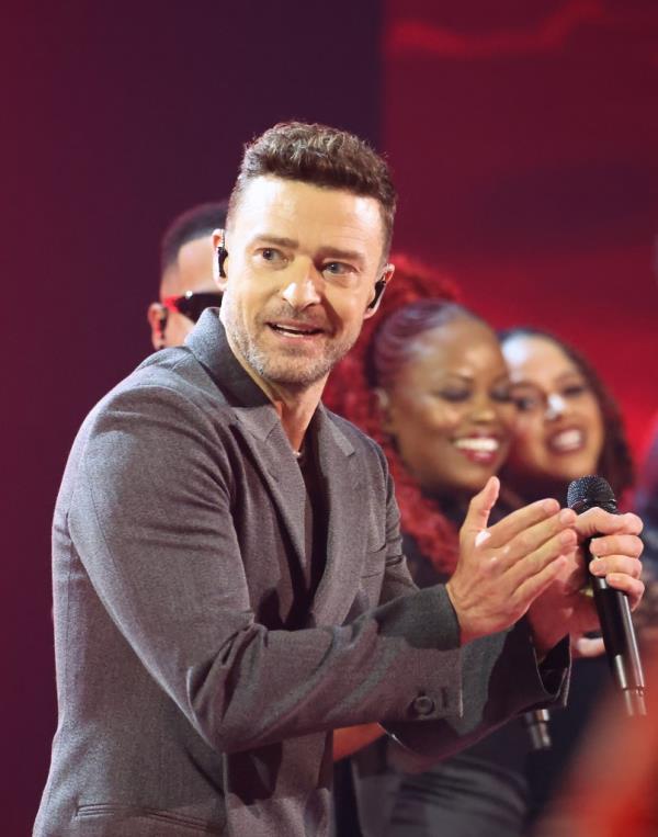 Justin Timberlake performing o<em></em>nstage at the 2024 iHeartRadio Music Awards in Hollywood, California, holding a microphone