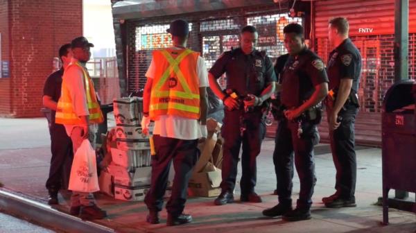 MTA worker Henry Herring is seen with NYPD officers after he was allegedly slashed on both his hands July 31, 2024, at 179th St - Hillside Ave. Station in Queens.