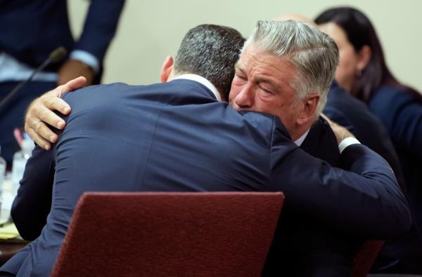 Alec Baldwin crying as he hugs his lawyer in court.