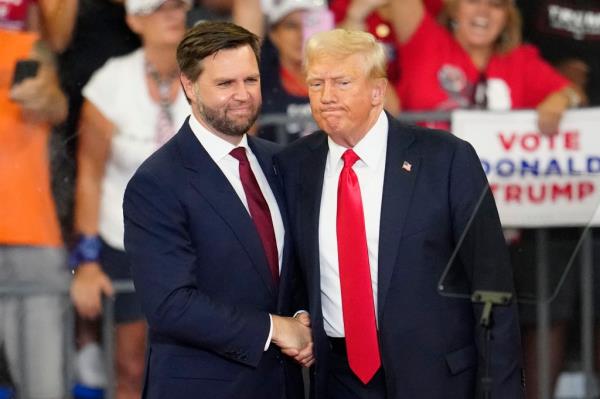 Former President Do<em></em>nald Trump and Senator JD Vance shaking hands at a campaign rally in Georgia State University, 2024