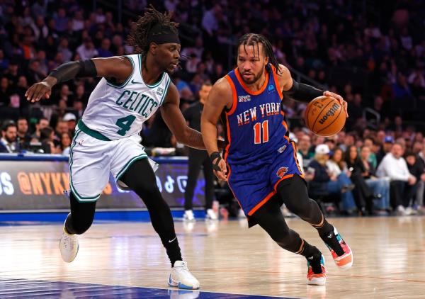 Jalen Brunson #11 of the New York Knicks drives to the basket as Jrue Holiday #4 of the Boston Celtics gives chase