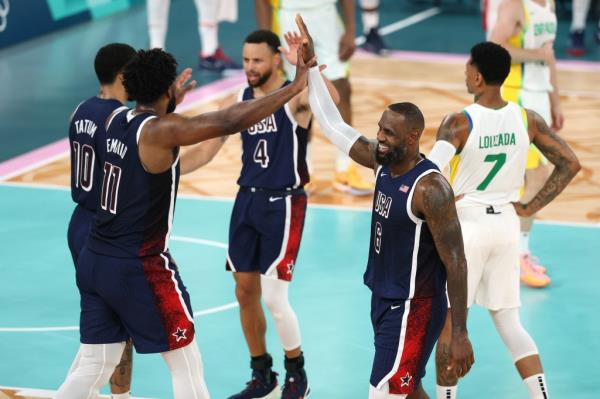 Joel Embiid #11 of Team United States high fives Lebron James #6 of Team United States during a Men's basketball quarterfinal game between Team United States and Team Brazil.