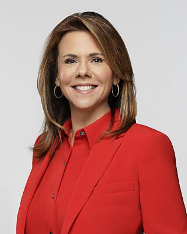 Adrienne Roark, President of CBS Television Stations, wearing a red suit