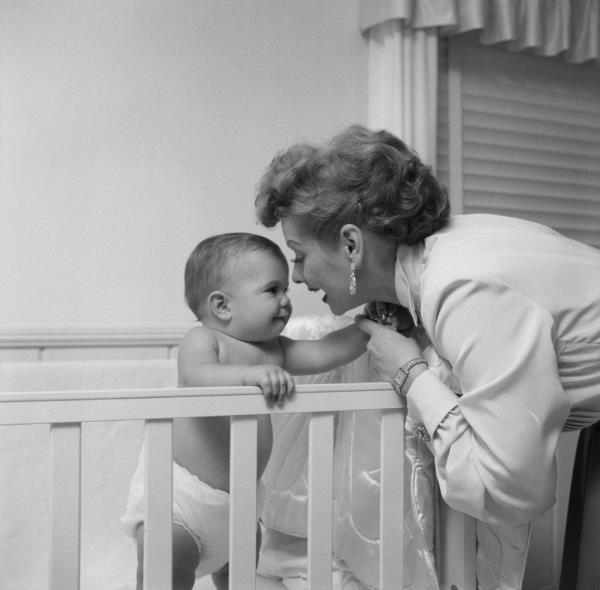 Lucille Ball kissing her baby son. 