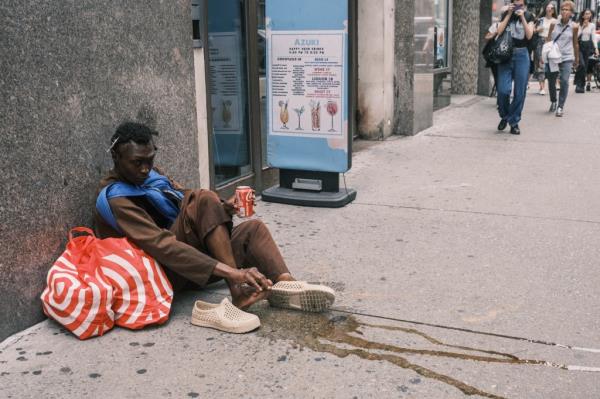 Times Square migrant wets himself.