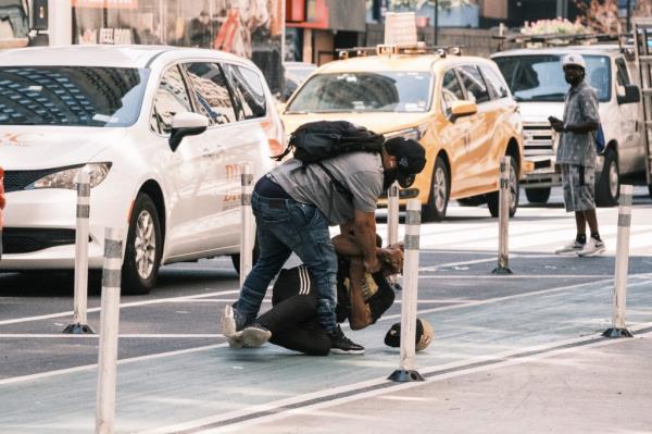 Vagrants fight on Eighth Avenue.