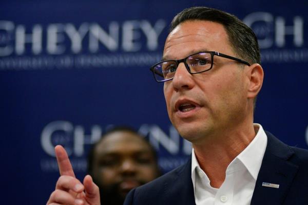 Pennsylvania Governor Josh Shapiro delivering remarks at a bill signing event at Cheyney University, pointing upwards