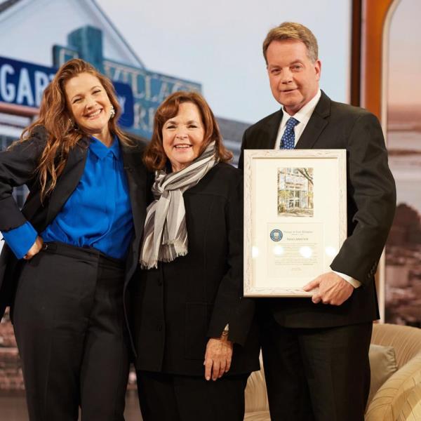 Mayor of East Hampton and Ina Garten posing for a photo together during a proclamation event