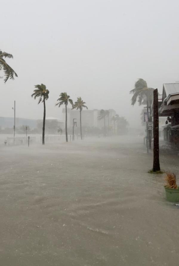 Street flooding in Fort Myers, Florida caused by rain from Hurricane Debby, August 4, 2024, with trees and buildings in the background