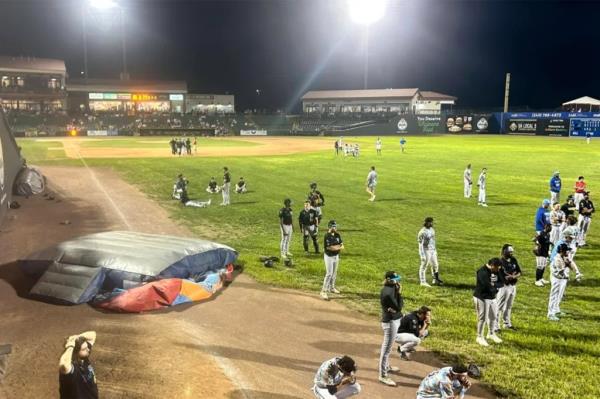 Group of people on a ba<em></em>seball field after a bounce house unexpectedly flew o<em></em>nto the field during a Southern Maryland Blue Crabs game