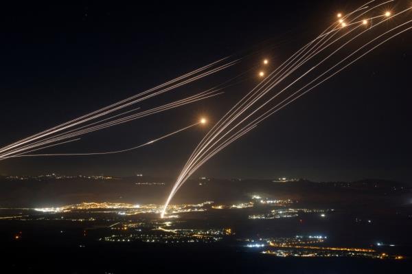 Rockets being intercepted by Israel's Iron Dome air defence system over the Upper Galilee region during cross-border clashes on August 4, 2024