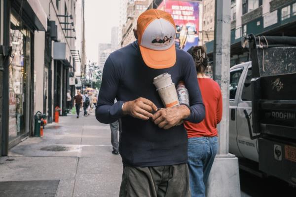 A man injects drugs into his hand near 8th avenue in midtown Manhattan.