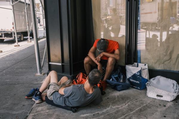 Two drug users nod out on 30th street and Broadway in midtown Manhattan. 