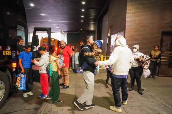 A bus full of migrants arrives and offloads at New York City's Port Authority Bus Terminal.