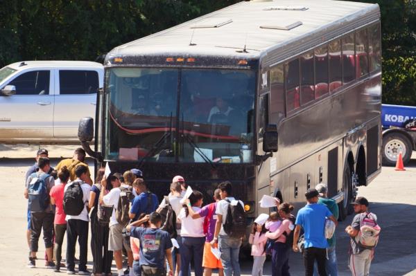 Migrants boarding a bus that was reportedly transporting them to New York City in Eagle Pass, Texas on Sep. 22, 2023.