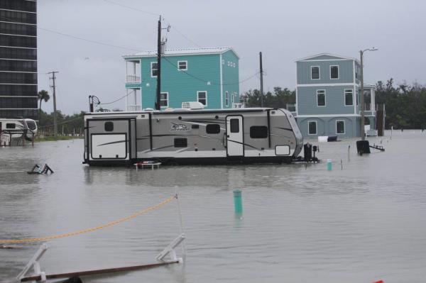 A car driving through a flood street in Fort Myers.