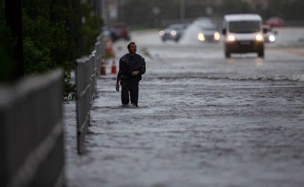 A man walking to his home through flood waters in Fort Myers.