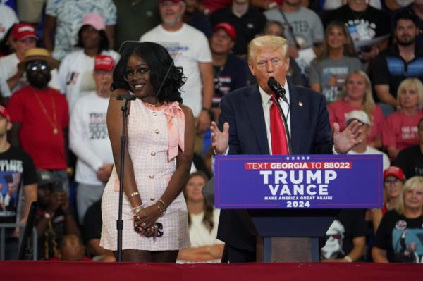 Michaelah Mo<em></em>ntgomery reacting to former U.S. President Do<em></em>nald Trump speaking at a campaign rally stage with Senator JD Vance in Atlanta, Georgia, 2024