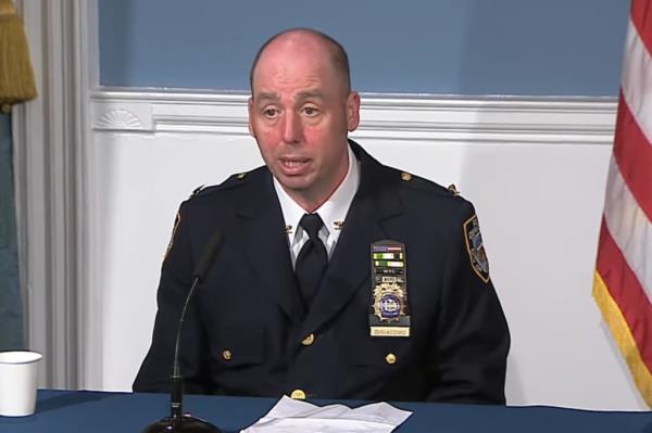 NYPD Deputy Chief Frank DiGiacomo in uniform sitting at a microphone during a briefing