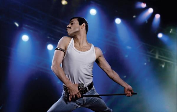 Rami Malek playing guitar as Freddie Mercury 