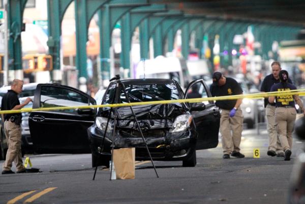 The scene in Queens shows several evidence markers for shell casings.