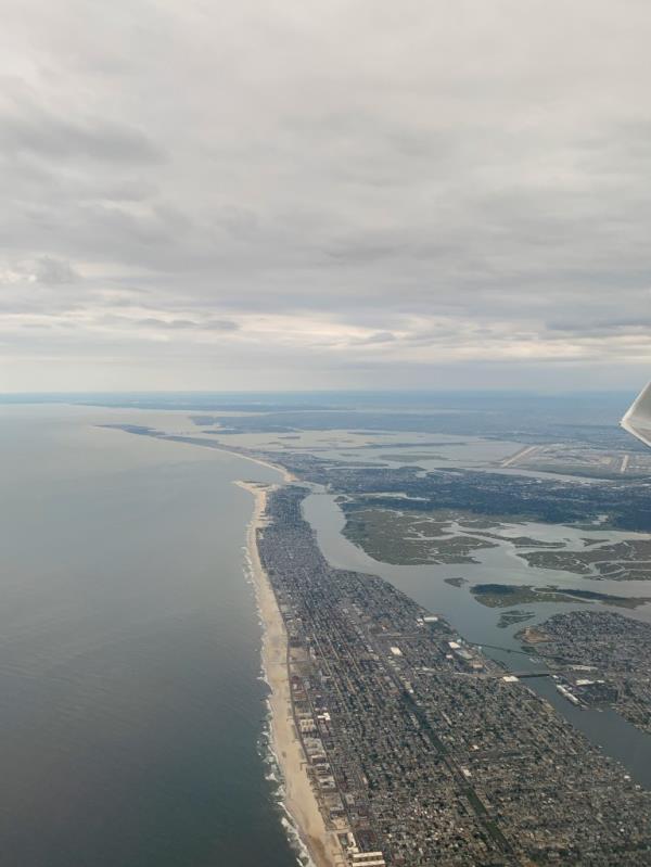 An aerial view of stormy Nickerson and Lido Beach in New York, with cityscape in the background and Nassau County's shark patrol on duty