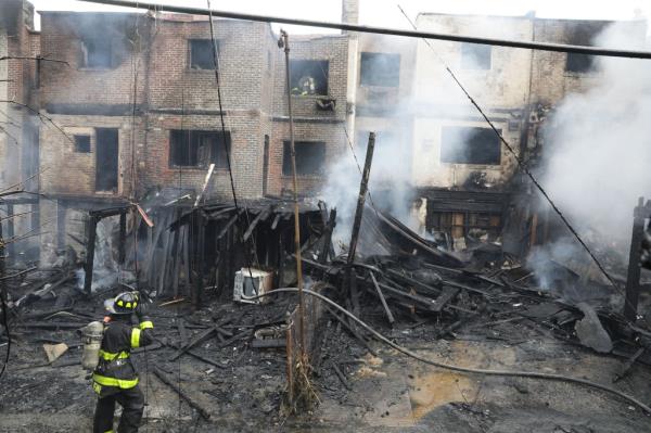 Fire damage in the backyards of several buildings.