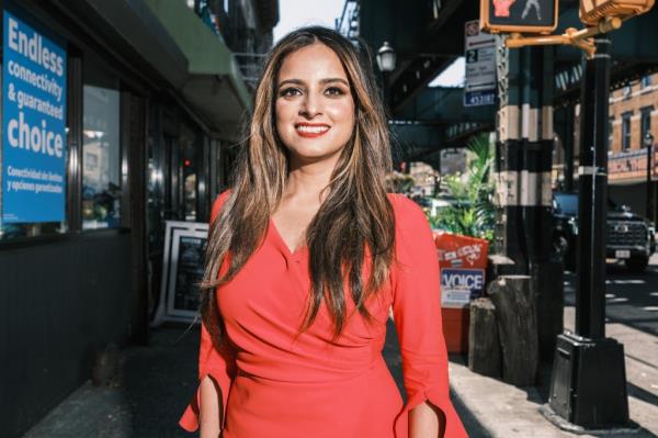 Assemblywoman Jenifer Rajkumar, the first Indian-American woman elected to a New York State Office, in a red dress in Woodhaven, Queens