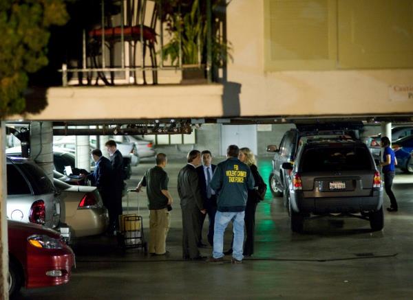 FBI agents stand in the ground floor parking garage of the apartment building in Santa Monica, Calif., wher<em></em>e fugitive crime boss James "Whitey" Bulger