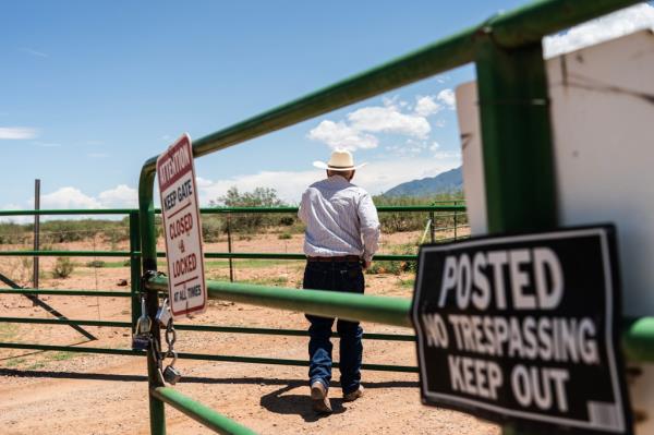 John Ladd opens a gate to his ranch which is located at the U.S.-Mexico border in  Hereford, Arizona on August 1, 2024.