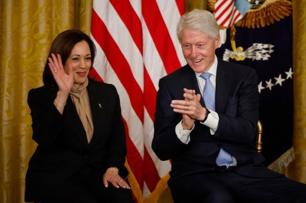 Vice President Kamala Harris and former President Bill Clinton sitting together at the White House, marking the 30th anniversary of the Family and Medical Leave Act