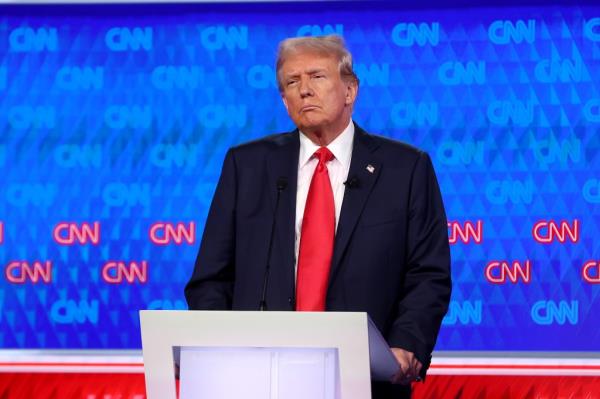 Former U.S. President Do<em></em>nald Trump debating with U.S. President Joe Biden at a podium during the first Presidential Debate 2024 in Atlanta, Georgia