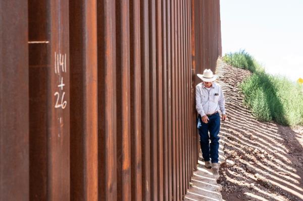 John Ladd walks along the border wall in  Hereford, Arizona on August 1, 2024.