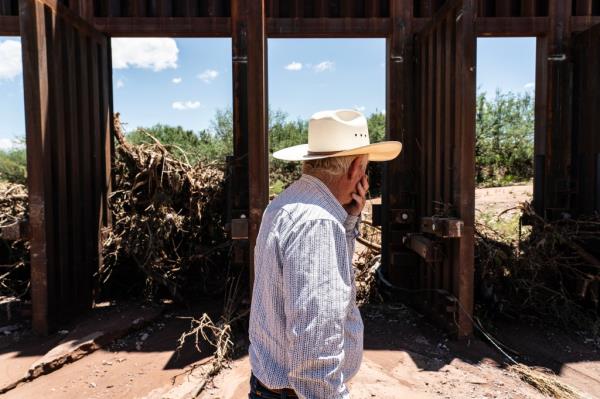 The owner of Ladd's San Jose Ranch John Ladd stands in front of an opened flood gate on the border wall in  Hereford, Arizona on August 1, 2024