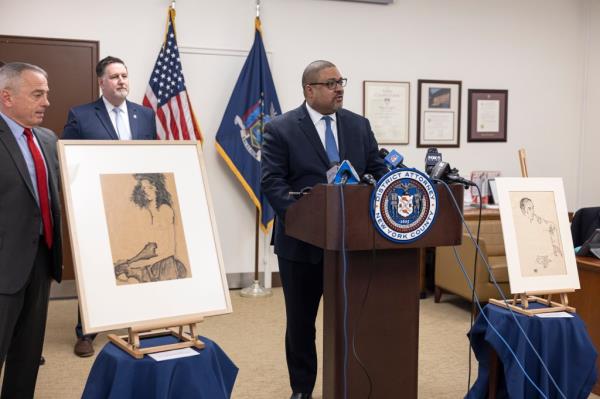 District Attorney Alvin Briggs speaking at a podium during a press co<em></em>nference regarding the recovery of Nazi-looted Egon Schiele paintings.