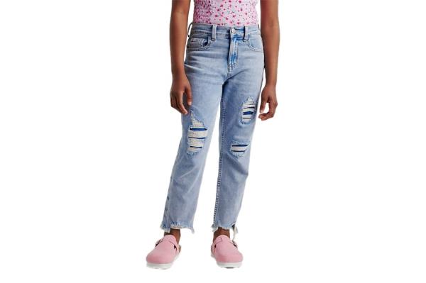 A person wearing jeans and pink shoes