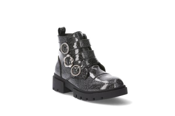 A black boot with silver buckles