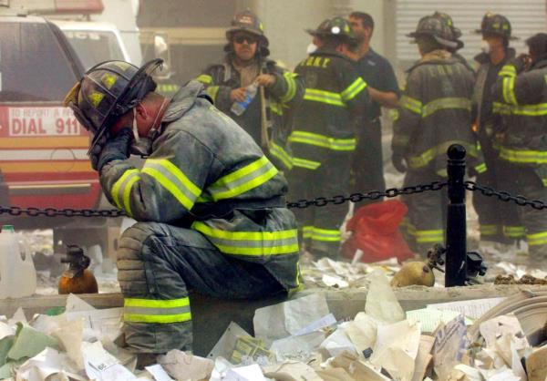 SEPTEMBER 11:  Firefighter Gerard McGibbon, of Engine 283 in Brownsville, Brooklyn, prays after the World Trade Center buildings collapsed September 11, 2001 after two hijacked airplanes slammed into the twin towers in a terrorist attack that killed some 3,000 people