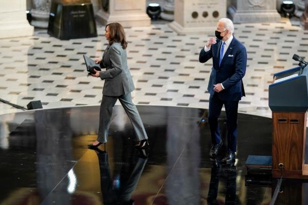 President Joe Biden and Vice President Kamala Harris cross paths as they deliver respective remarks to mark the one-year anniversary of the January 6th Capitol insurrection in Statuary Hall on Capitol Hill on January 6, 2022 in Washington, DC.